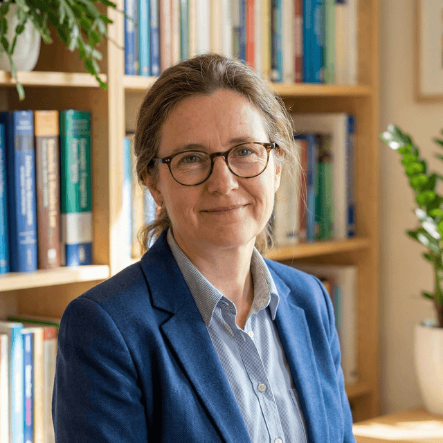 Professional teacher headshot with friendly, knowledgeable appearance