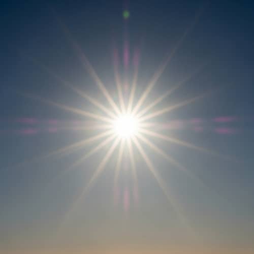 Vivid Sun at High Noon: Radiant Colors in Cloudless Sky