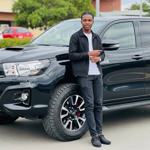 Stylish African Man with Black Hilux - Fashionable Pose