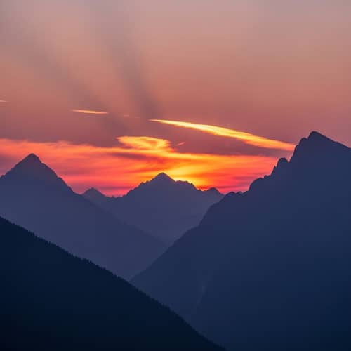 Tranquil Sunset Scene: Majestic Mountains in Lavender Sky