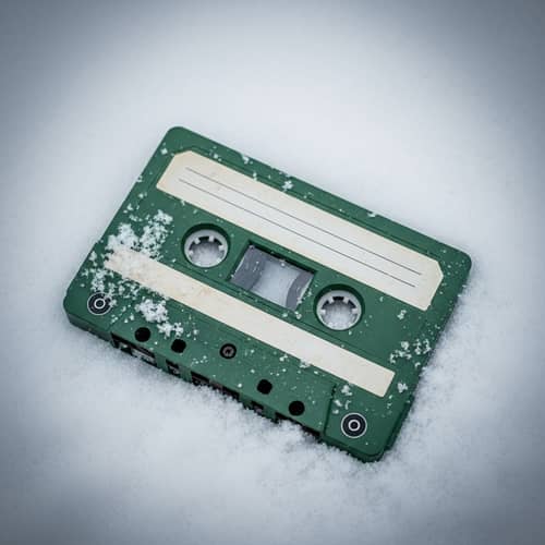 Melancholic Green Cassette in Snow - Nostalgic Photorealistic Image