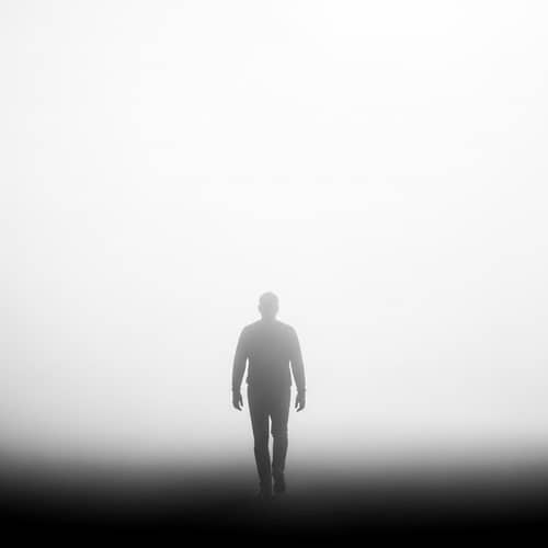 Silhouette Man Walking Away in Fog
