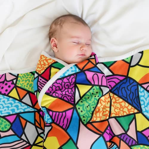 Adorable Sleeping Baby in Colorful Swaddle Blanket