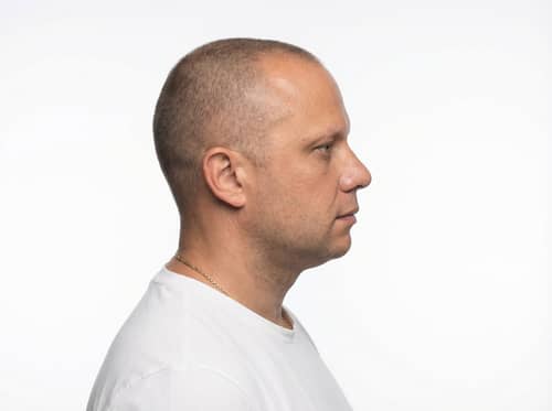 Studio Portrait of a Man in Profile Against White Studio Portrait of a Man in Profile Against White