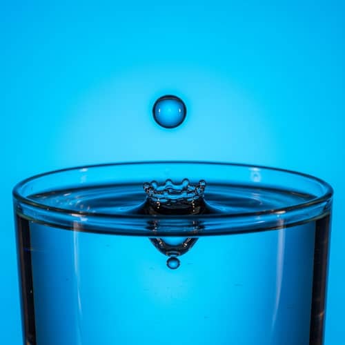 Captivating Water Drop in Vibrant Blue Glass