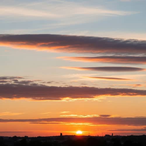 Soft Realistic Sunset with Horizontal White-Blue Clouds