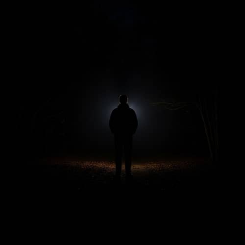 Solitary Figure in Dark Shadow: A Compelling Image of Solitude and Peace