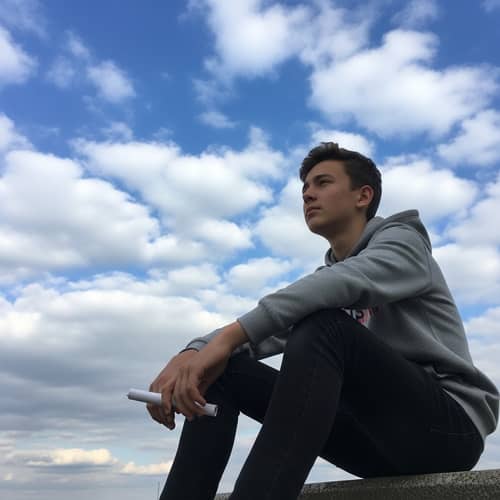 Contemplative Teen Boy Looking Up at Sky | Thoughtful Image
