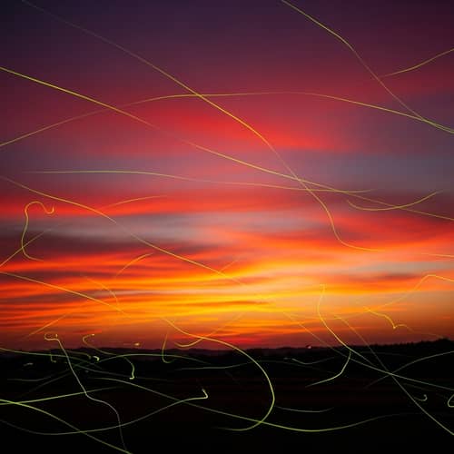 Stunning Sunset Backdrop with Glowing Fireflies