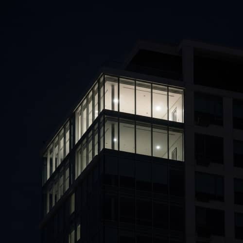Mysterious Glass Apartment in High-Rise at Night