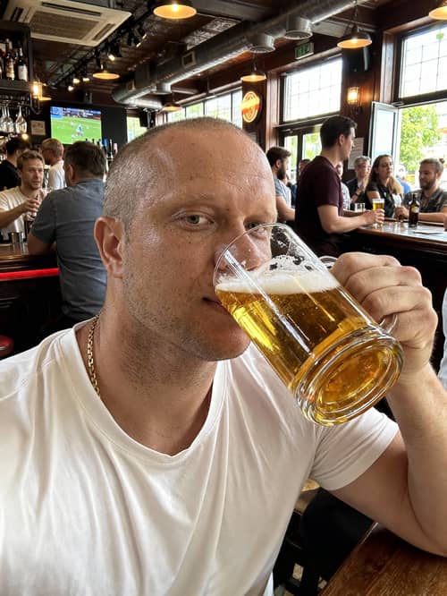 Model Enjoying Beer in a Bustling Bar Model Enjoying Beer in a Bustling Bar