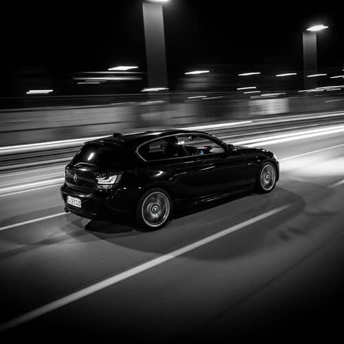 Sleek Black BMW 118d Racing on Open Road