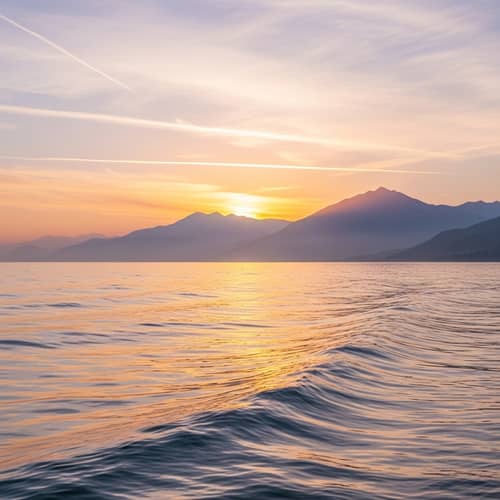 Serene Seascape with Mountains at Dawn