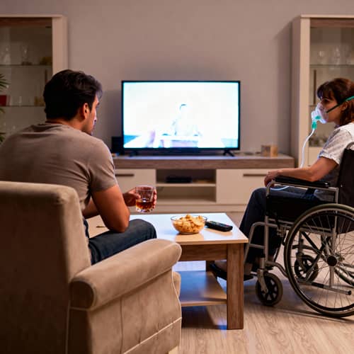 Drunk Man on Couch with Woman in Wheelchair