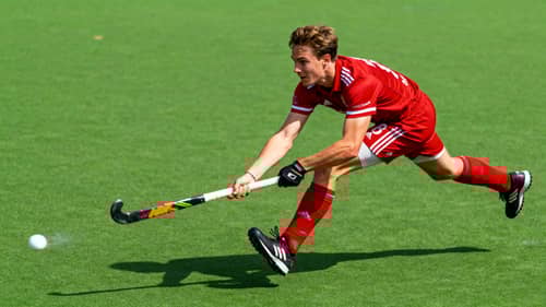 Dynamic Field Hockey Action Shot in Red Jersey