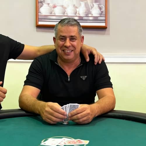 Poker Player with Cards at the Table Poker Player with Cards at the Table