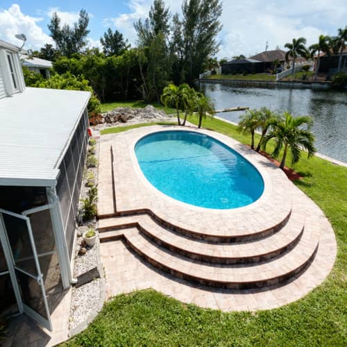 Elegant Oval Above Ground Pool with Paver Deck