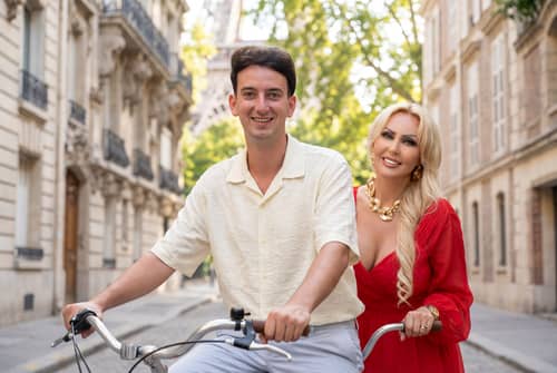 Couple Riding Tandem Bike in Beautiful City Couple Riding Tandem Bike in Beautiful City