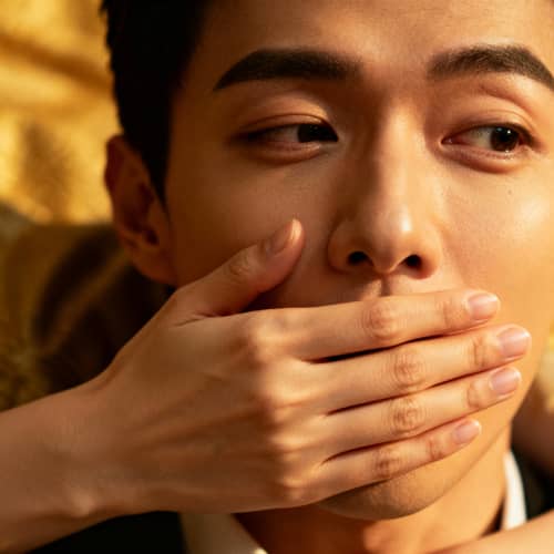 Intriguing Moment: A Woman's Hand Over a Man's Mouth Intriguing Moment: A Woman's Hand Over a Man's Mouth