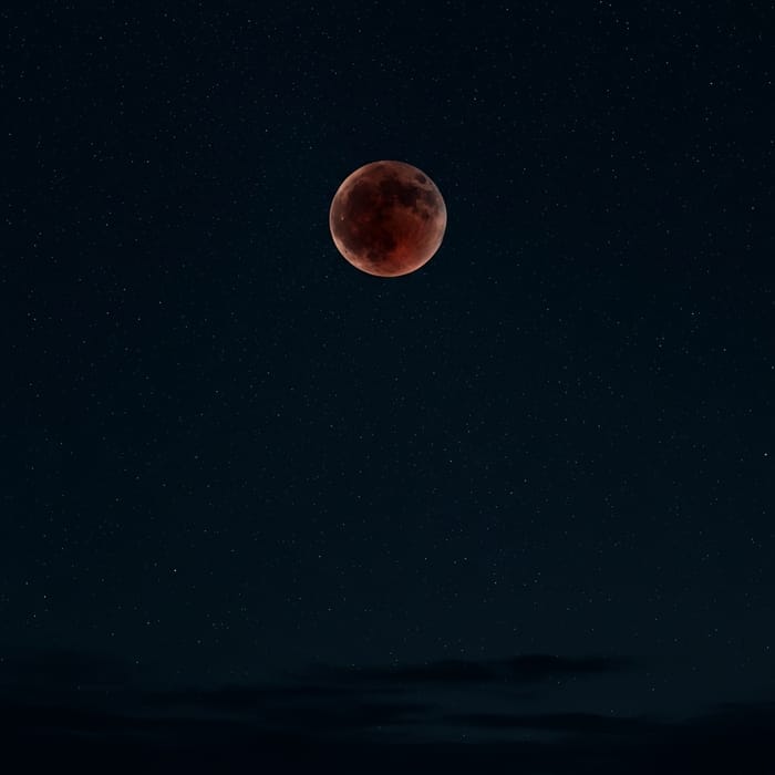 Spectacular Blood Moon in Starry Night Sky
