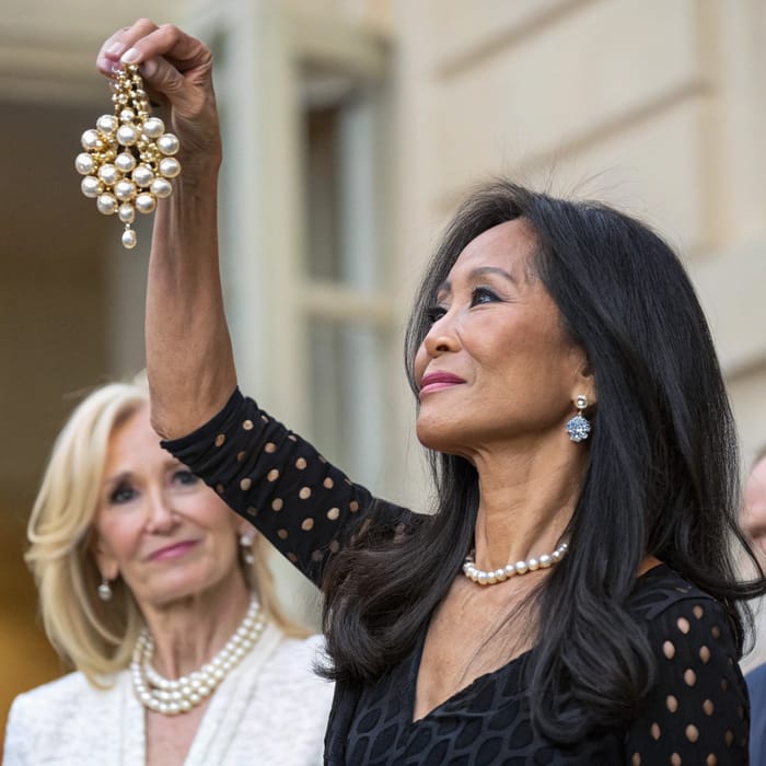 Elegant Women Showcasing Pearl Brooch