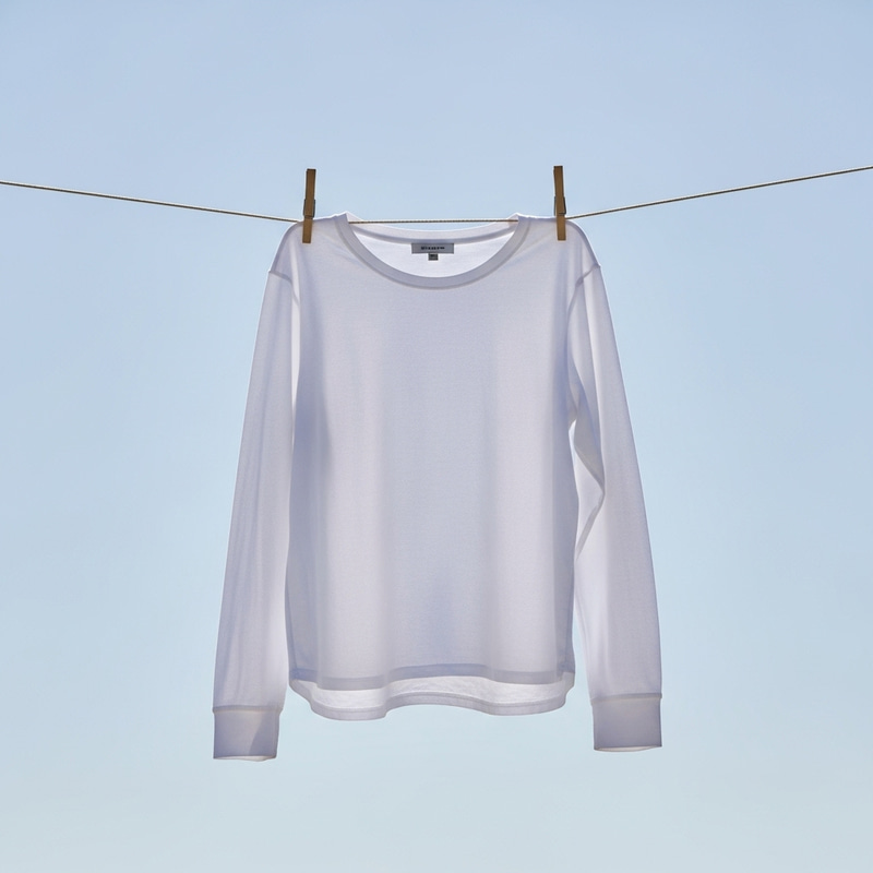 Solid White Long Sleeve Shirt | Close-Up on Blue Sky