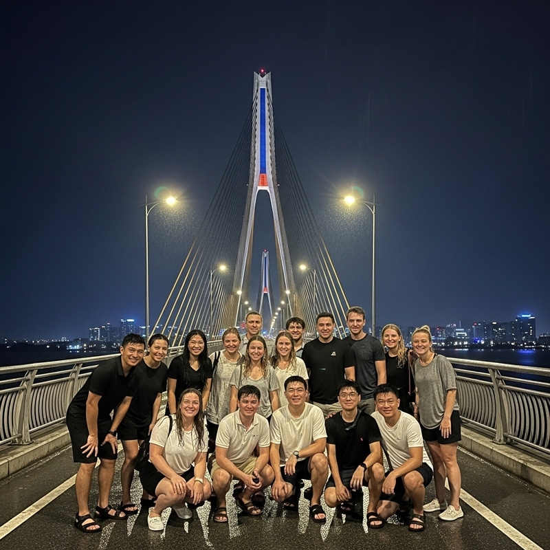 Cheerful Agency Trip of 17 People at Danang Bridge in the Rain