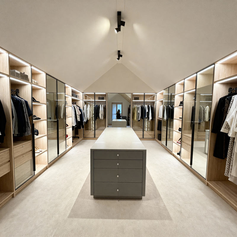 Elegant Sloped-Ceiling Walk-In Closet Design Elegant Sloped-Ceiling Walk-In Closet Design