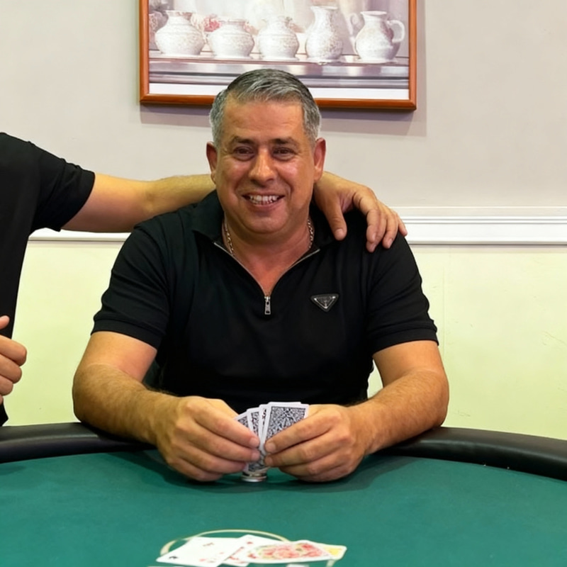 Poker Player with Cards at the Table Poker Player with Cards at the Table