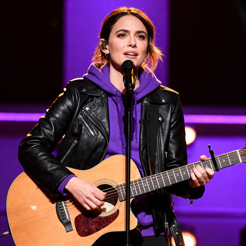 Woman on Stage with Guitar: Leather & Hoodie Style Woman on Stage with Guitar: Leather & Hoodie Style
